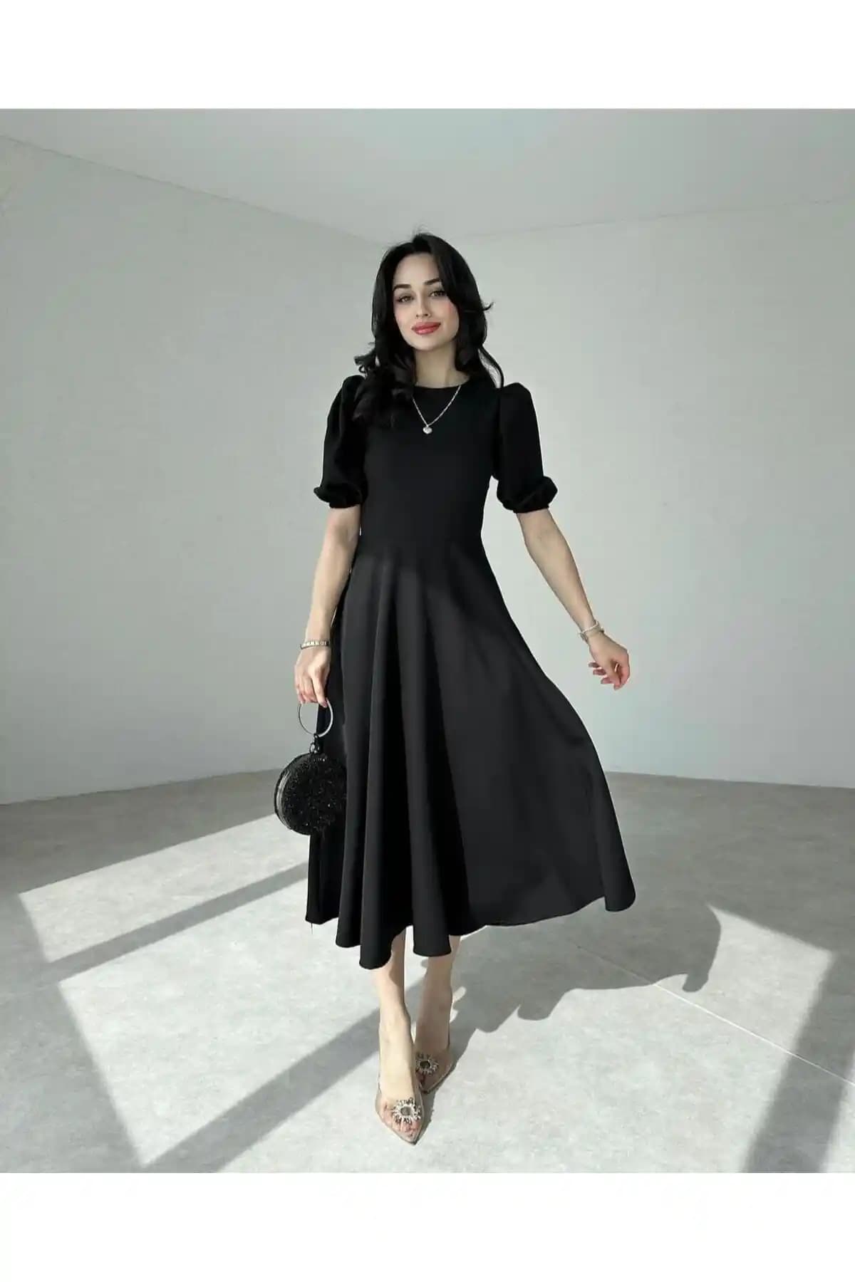 Afiş Butik Siyah Karpuz Kollu Midi Boy Elbise: Şıklık ve Konforun Modern Buluşması